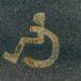 a handicapped sign is painted on the pavement