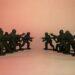 Toy soldiers in a standoff against each other.