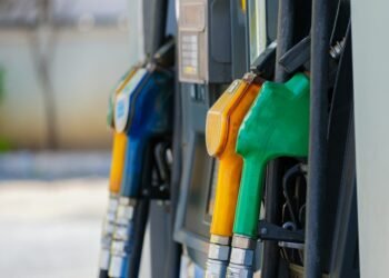 a row of gas pumps filled with gas