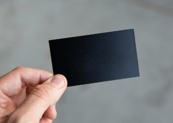 person holding black rectangular paper
